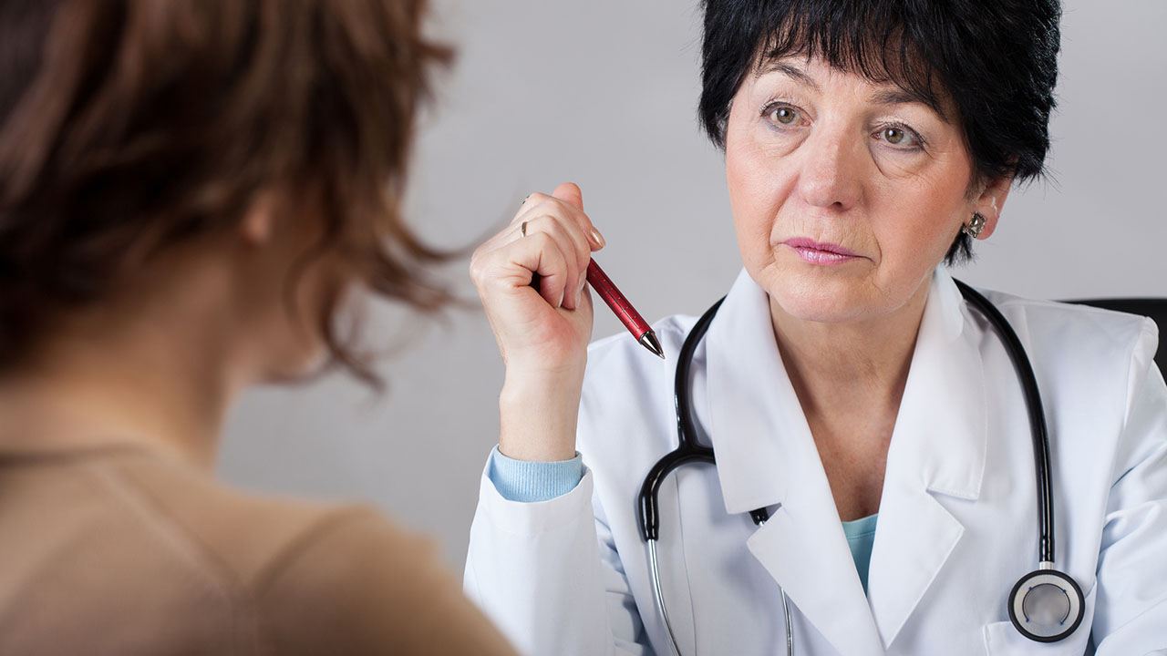 Female doctor speaks with patient
