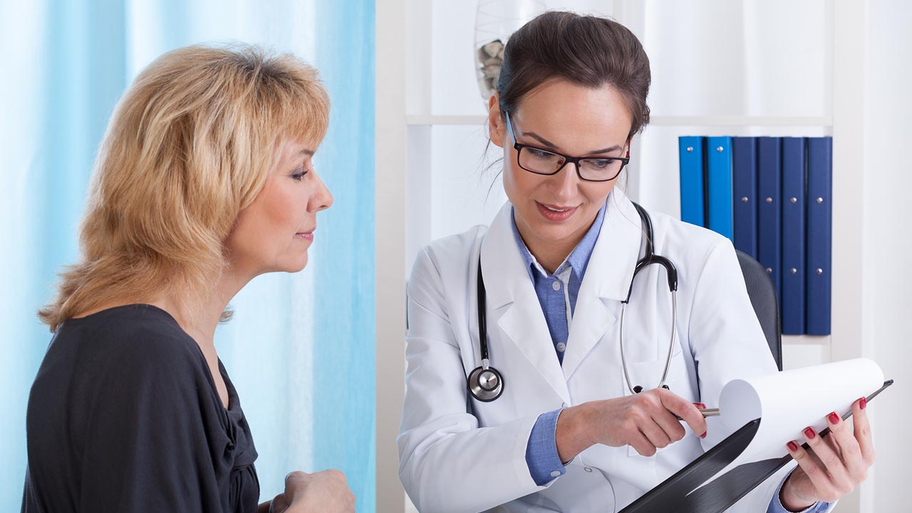 Doctor discusses notes with patient